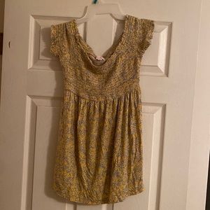 Yellow floral off the shoulder shirt.